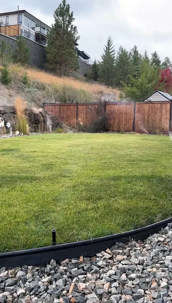 Air and water misting from sprinkler heads on a Kamloops lawn during an irrigation blow-out